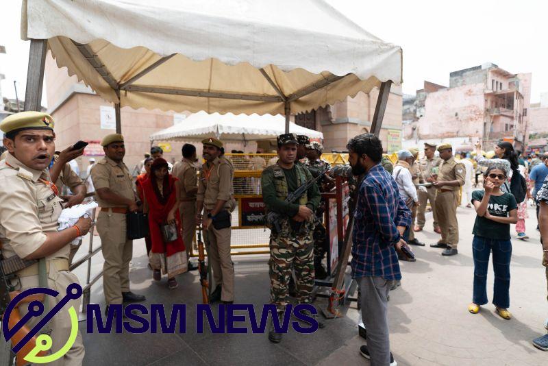 Guards patrol the street outside the Gyanvapi Mosque.