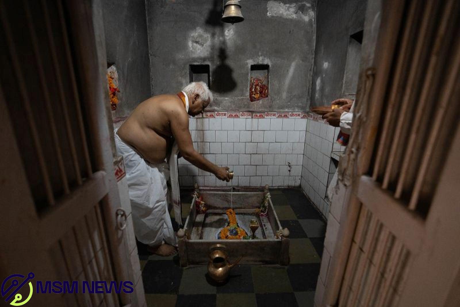 Vishwambhar Nath Mishra prays inside his temple in Varanasi.